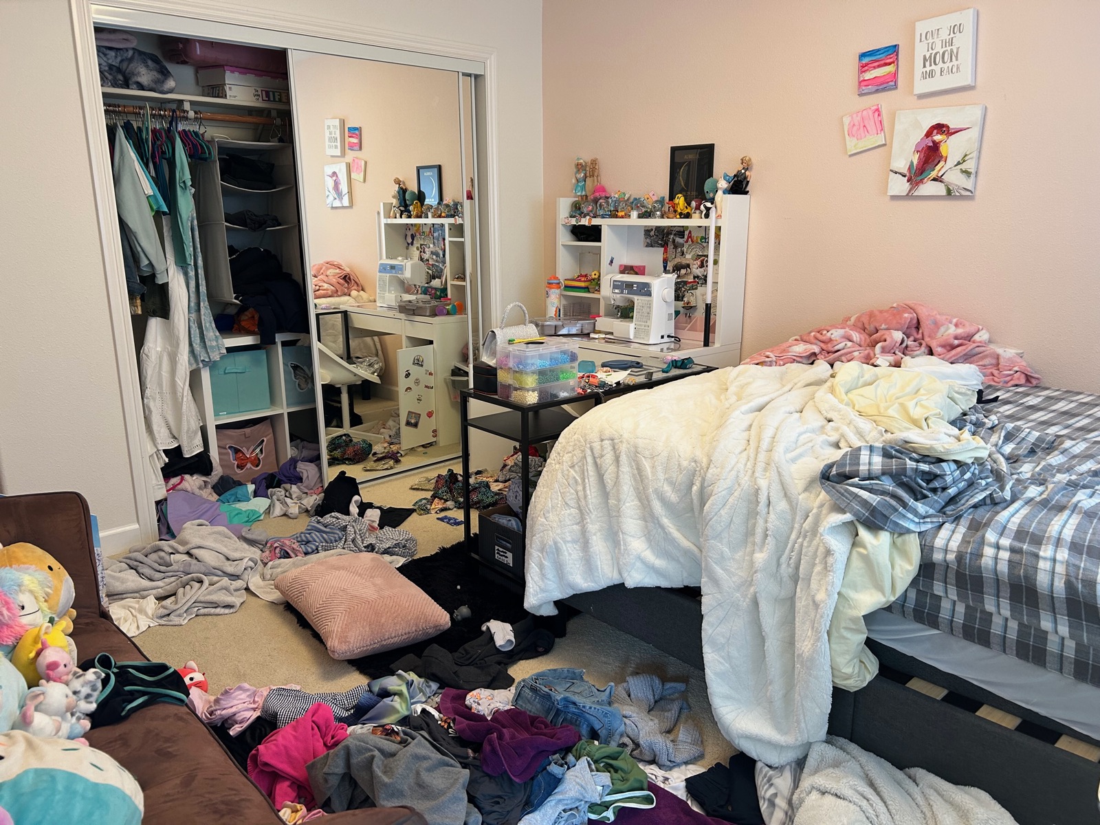 Bedroom before organizing — clothes and belongings scattered across the floor and bed